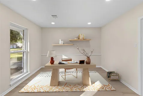 a kitchen with a refrigerator and wooden cabinets