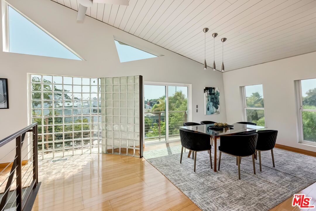 899 Commonwealth Avenue Venice, CA 90291 - Photo 3 of 47 a dining room with wooden floor and a floor to ceiling window