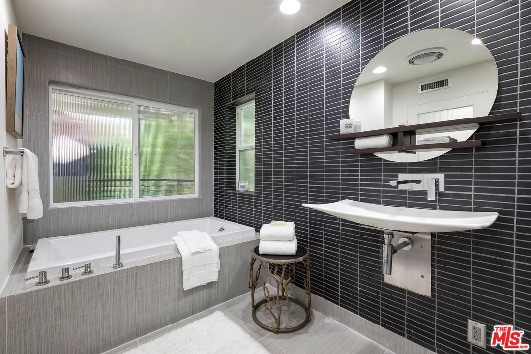 899 Commonwealth Avenue Venice, CA 90291 - Photo 23 of 47 a bathroom with a sink a toilet and mirror