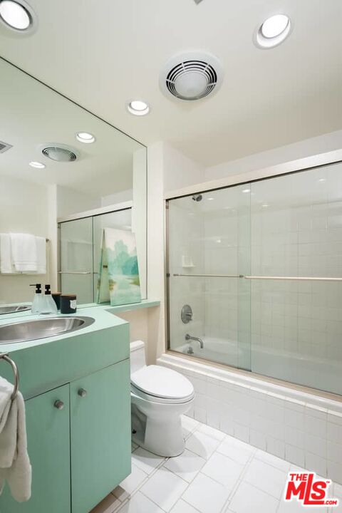 899 Commonwealth Avenue Venice, CA 90291 - Photo 28 of 47 a bathroom with a granite countertop sink a toilet a mirror and shower