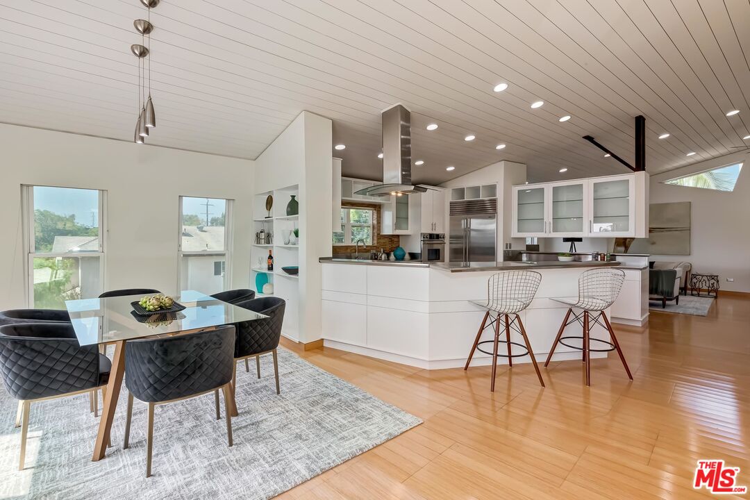 899 Commonwealth Avenue Venice, CA 90291 - Photo 4 of 47 a living room with stainless steel appliances kitchen island granite countertop furniture and a wooden floor