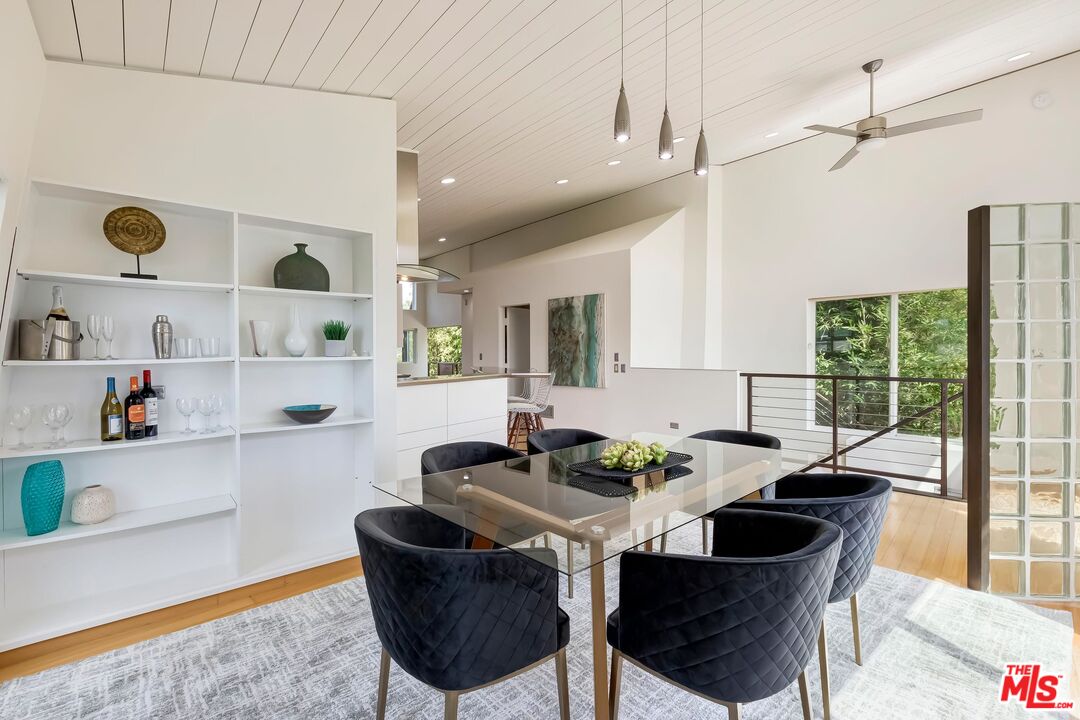 899 Commonwealth Avenue Venice, CA 90291 - Photo 5 of 47 a kitchen with a dining table chairs and white appliances