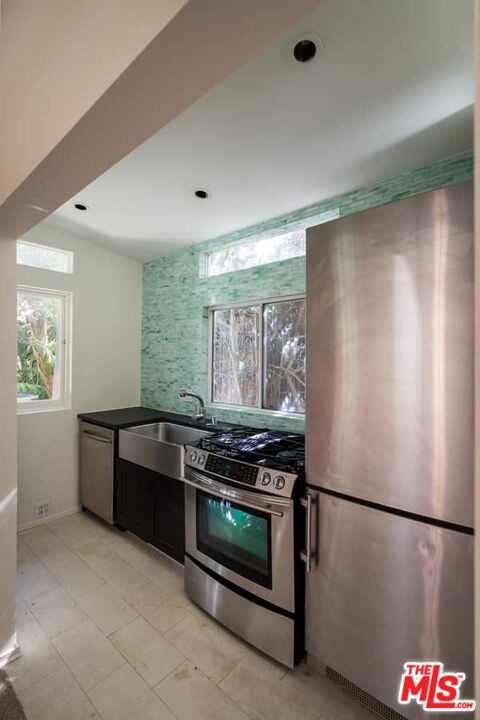 899 Commonwealth Avenue Venice, CA 90291 - Photo 45 of 47 a kitchen with stainless steel appliances granite countertop a refrigerator and a stove