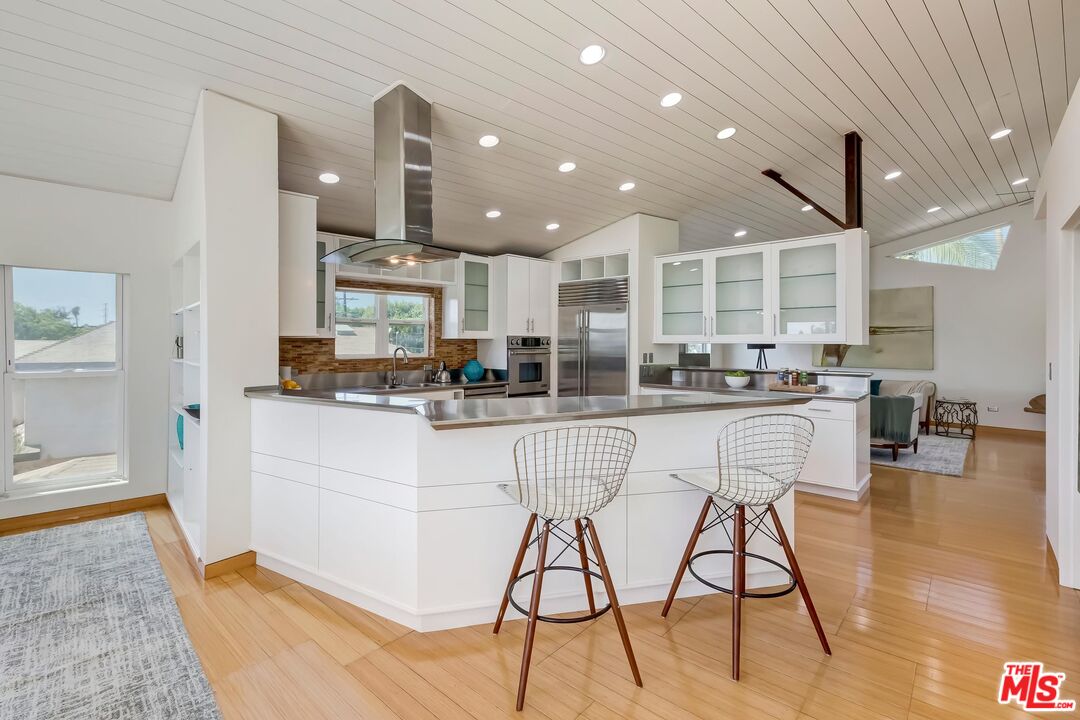 899 Commonwealth Avenue Venice, CA 90291 - Photo 6 of 47 a kitchen with stainless steel appliances kitchen island granite countertop a sink and cabinets