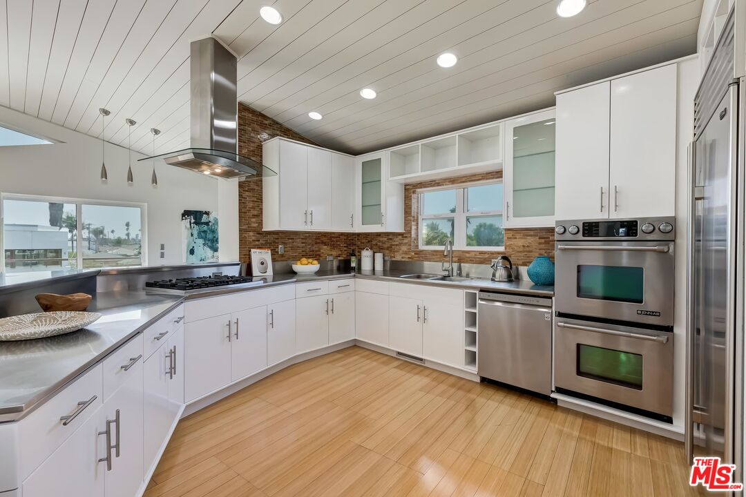 899 Commonwealth Avenue Venice, CA 90291 - Photo 8 of 47 a kitchen with stainless steel appliances granite countertop a stove a sink and a refrigerator