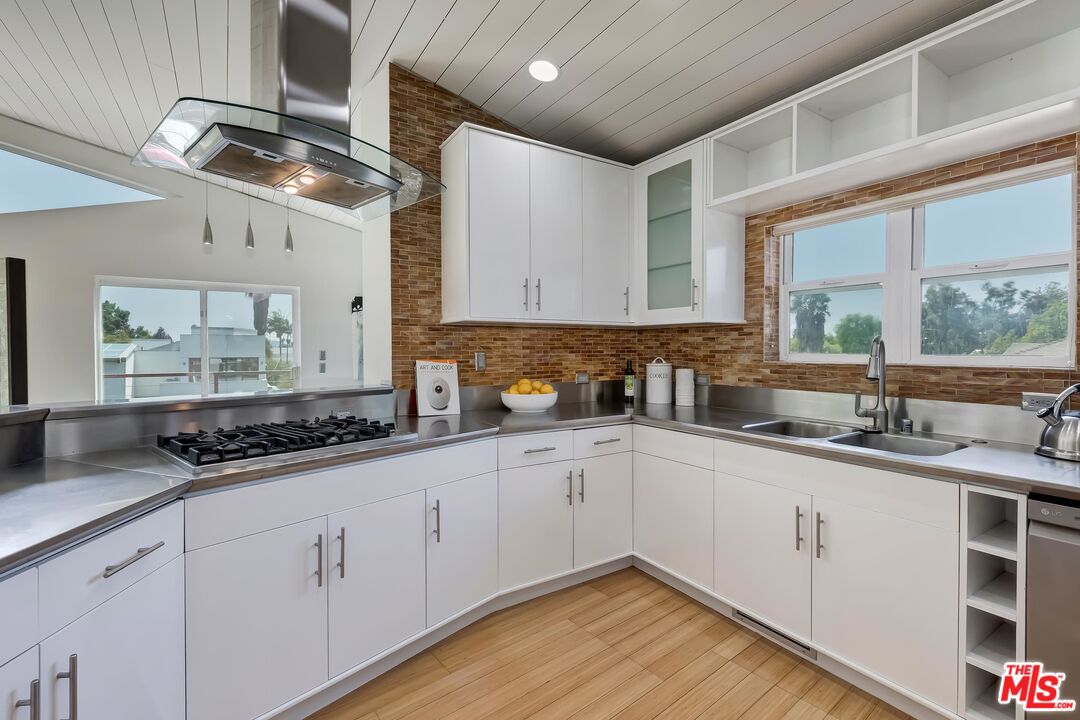 899 Commonwealth Avenue Venice, CA 90291 - Photo 9 of 47 a kitchen with granite countertop a sink stainless steel appliances and cabinets