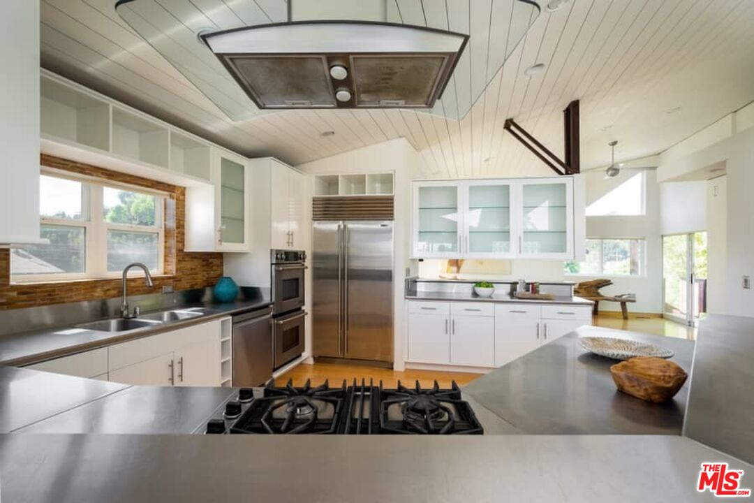 899 Commonwealth Avenue Venice, CA 90291 - Photo 10 of 47 a kitchen with stainless steel appliances a stove a sink and a refrigerator