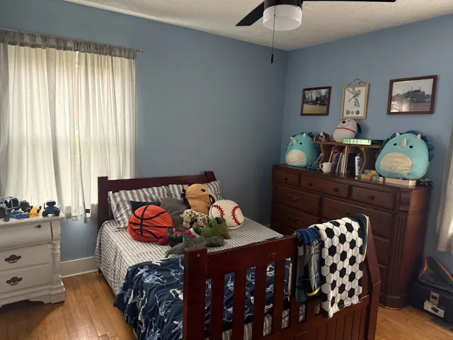 a bedroom with furniture and window