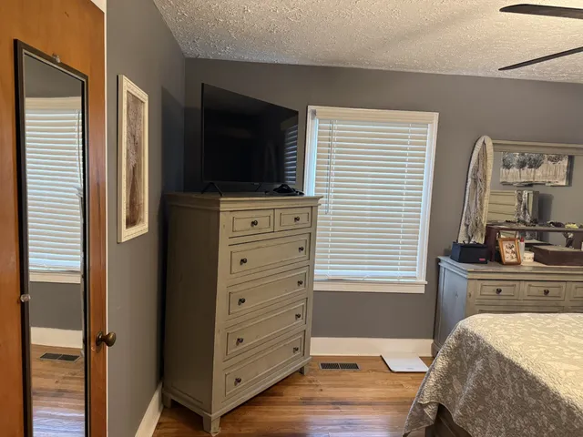 a bedroom with a bed and a television