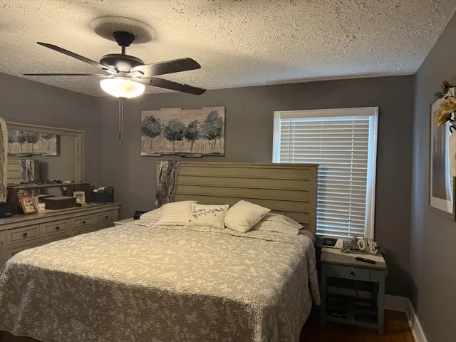 a bedroom with a bed and a chandelier