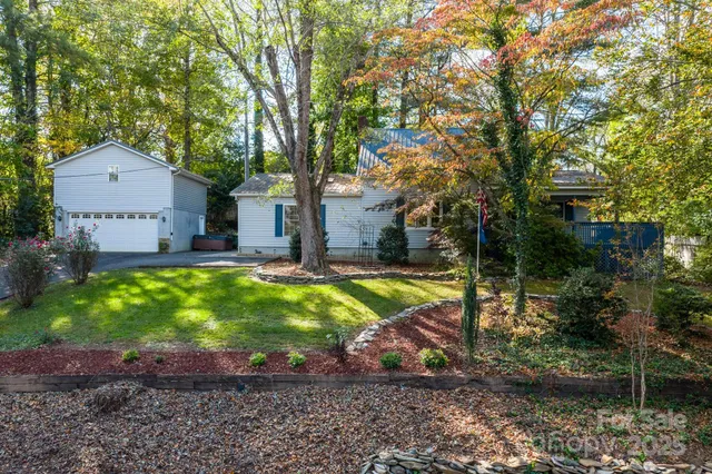 a view of a house with a yard and sitting area