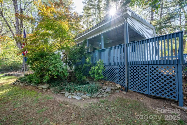 a view of a deck with wooden floor and roof with a chair