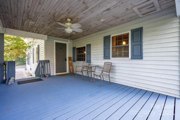 a view of a patio with table and chairs and wooden floor
