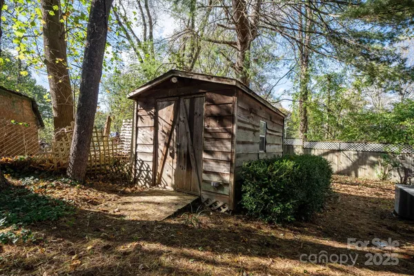 a view of a wooden house with a yard