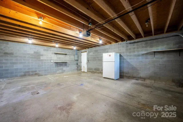a kitchen with granite countertop a sink a stove and cabinets