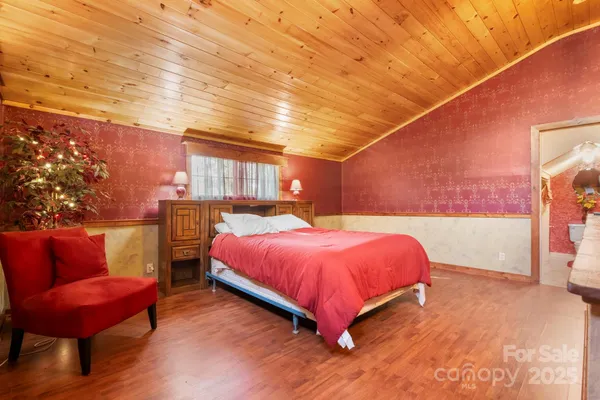 a bed room with a bed and a chair