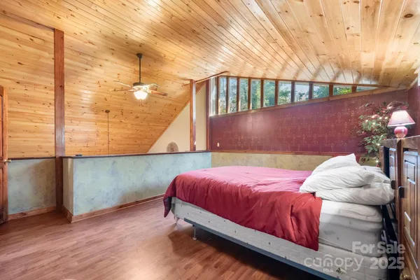 a bedroom with a bed and a potted plant