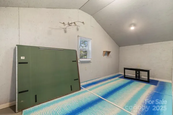 a view of a room with wooden floor and windows