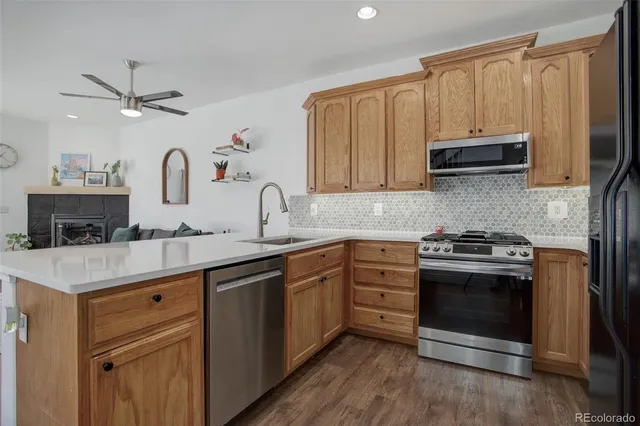 a kitchen with a refrigerator stove and cabinets