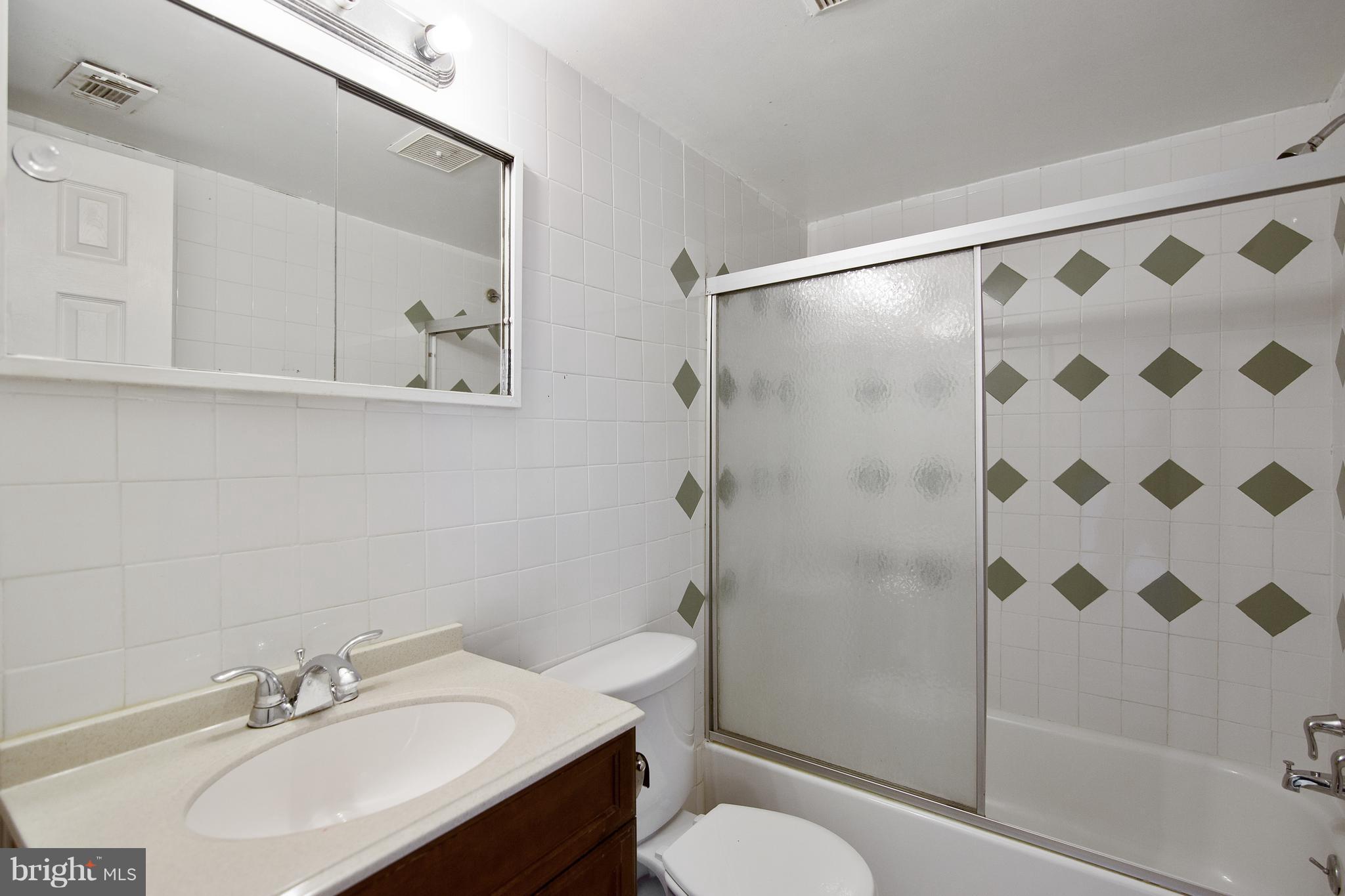 3946 Bel Pre Road, Unit 4 Silver Spring, MD 20906 - Photo 9 of 12 a bathroom with a sink toilet and shower