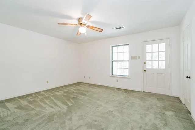 a view of a backyard with large trees