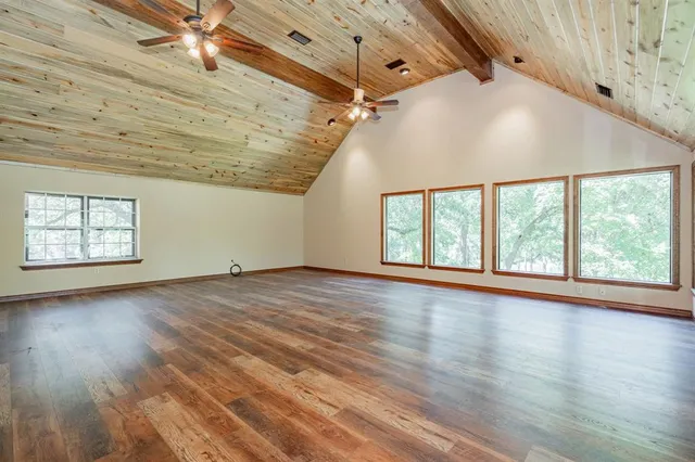 a view of a room with a large window and sitting space