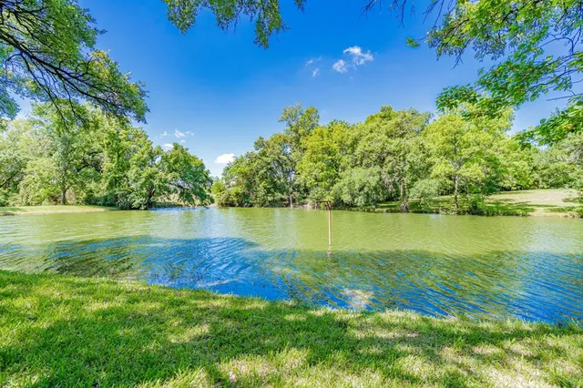 a view of a lake with houses in the background