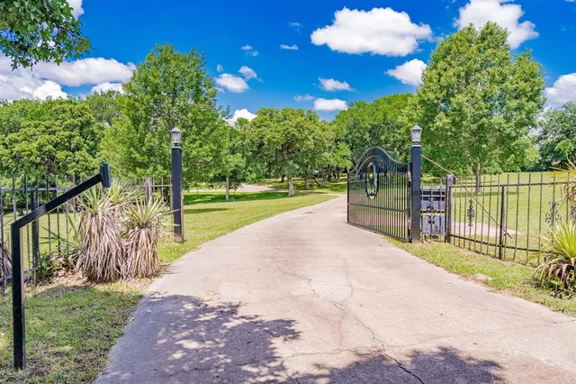 a view of a garden with swimming pool and green space
