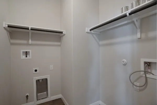 a large kitchen with kitchen island a island wooden floor stainless steel appliances and cabinets