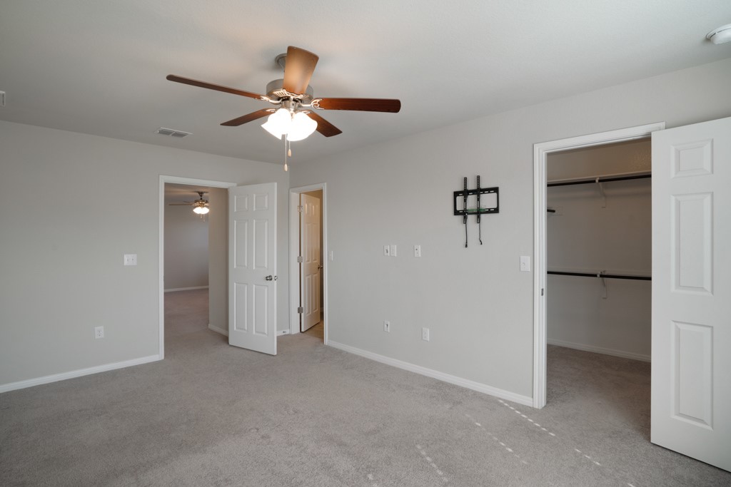 205 Guemal Road Buda, TX 78610 - Photo 19 of 33 a view of a livingroom with a ceiling fan and entryway