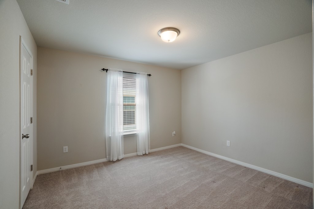 205 Guemal Road Buda, TX 78610 - Photo 21 of 33 an empty room with a empty space and windows