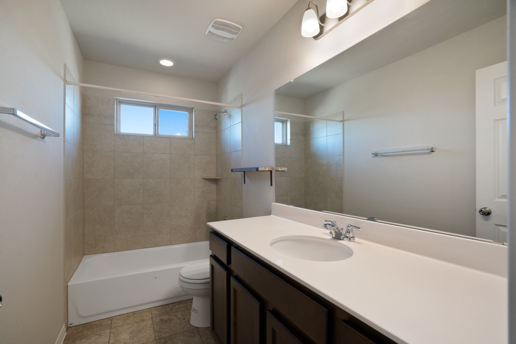 205 Guemal Road Buda, TX 78610 - Photo 24 of 33 a bathroom with a sink a toilet and shower