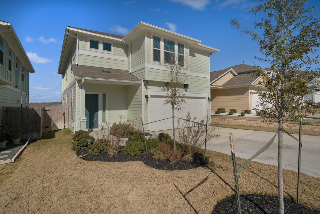 205 Guemal Road Buda, TX 78610 - Photo 3 of 33 a view of a house with many windows