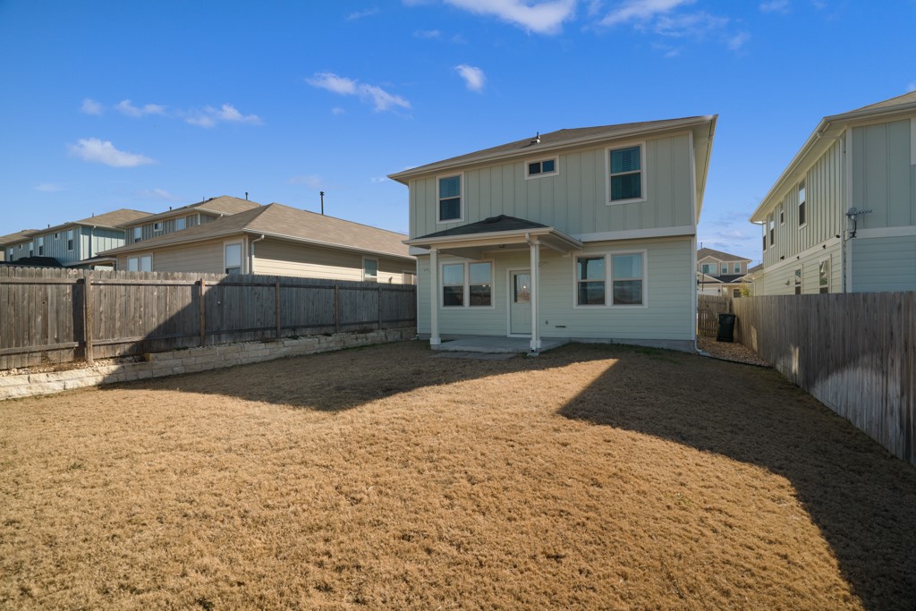 205 Guemal Road Buda, TX 78610 - Photo 28 of 33 a front view of a house with a yard