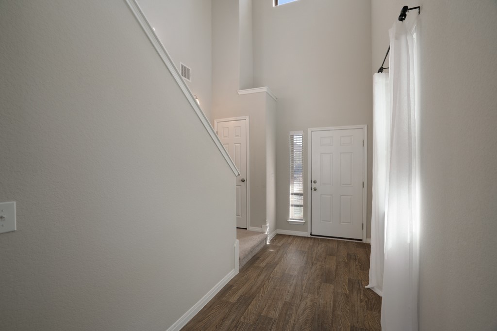 205 Guemal Road Buda, TX 78610 - Photo 5 of 33 a view of a hallway with wooden floor and entryway