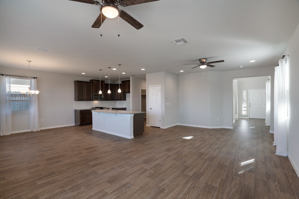 205 Guemal Road Buda, TX 78610 - Photo 32 of 33 a view of a kitchen with a sink stainless steel appliances and cabinets