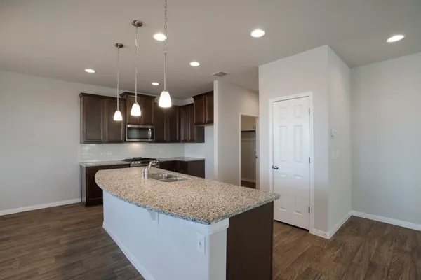a view of a kitchen with a sink stainless steel appliances and cabinets