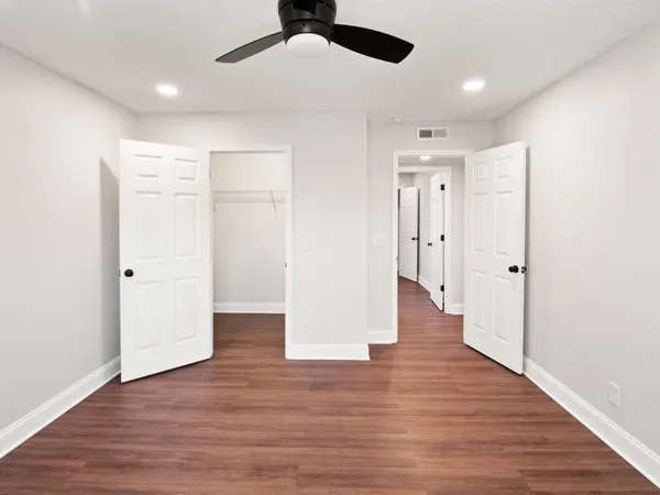 a view of an empty room with wooden floor