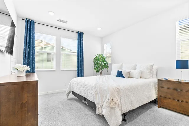 a bedroom with a large bed and a large window