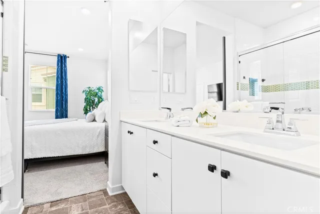 a bathroom with a double vanity sink mirror and bathtub