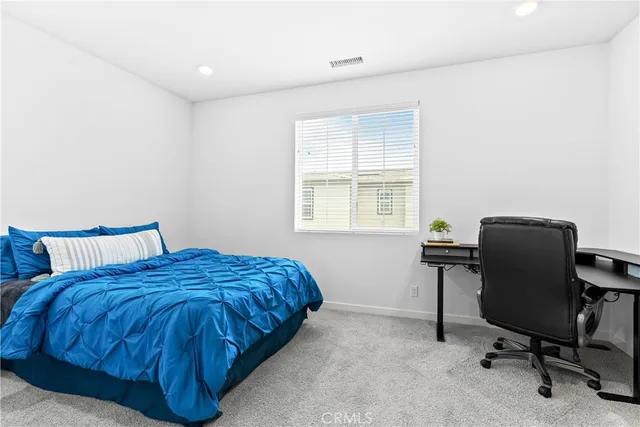 a bed room with a bed and a desk