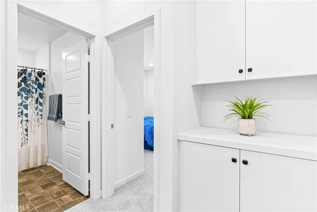 a white room with a potted plant