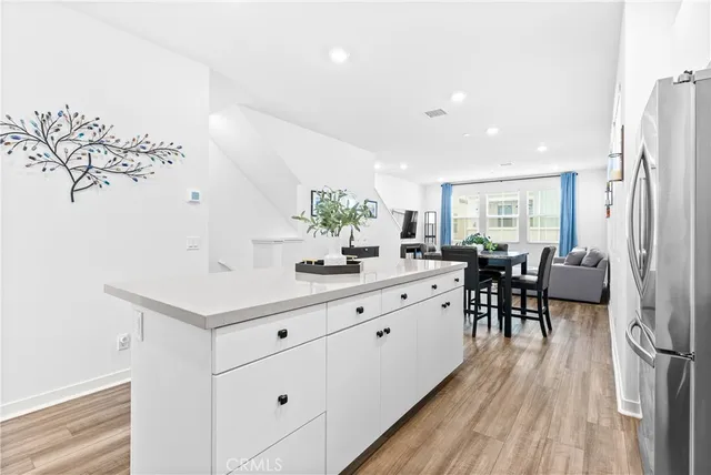 a kitchen with sink cabinets and wooden floor