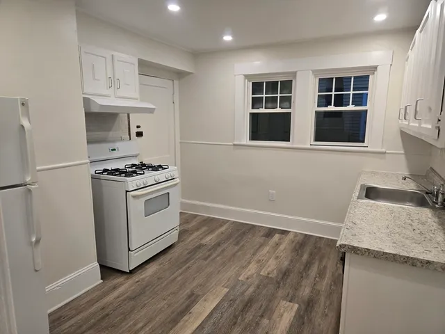 a kitchen with granite countertop a stove and a sink
