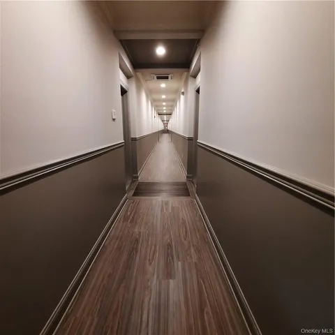 a view of gallery with wooden floor