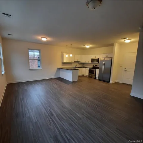 a view of kitchen with furniture and wooden floor
