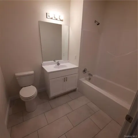 a bathroom with a toilet a sink and bathtub