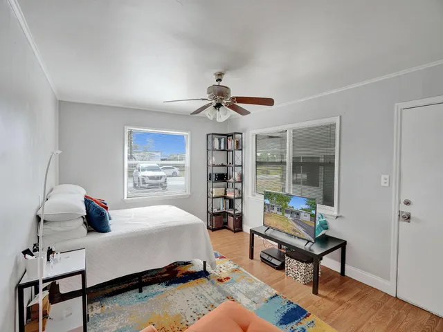 a bedroom with a bed and a chandelier