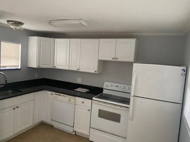 a white refrigerator freezer sitting inside of a kitchen