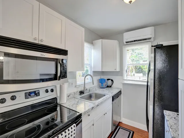 a kitchen with a stove a sink and a microwave